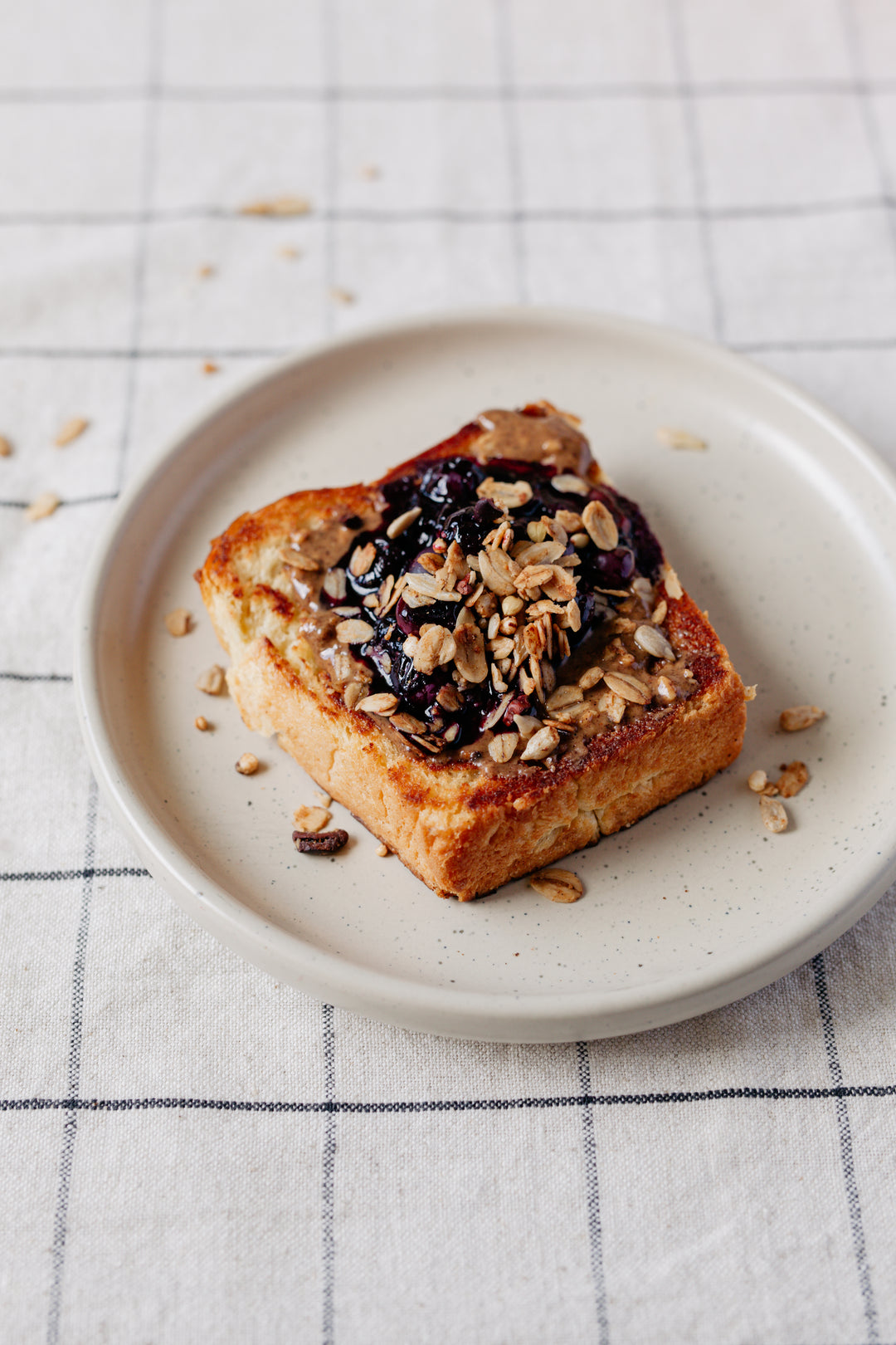 Brioche with hazelnut butter and granola on top