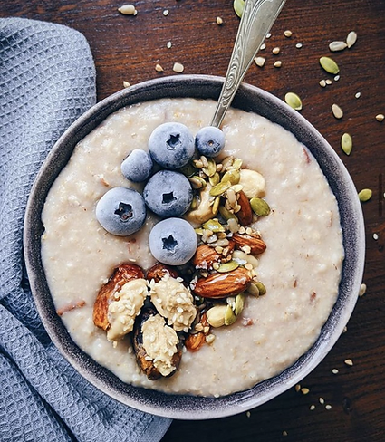 Healthy bowl of porridge with nuts, seeds and blueberries 