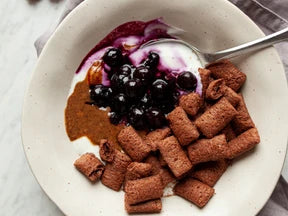 Cereal bowl with hazelnut and blueberry coulis